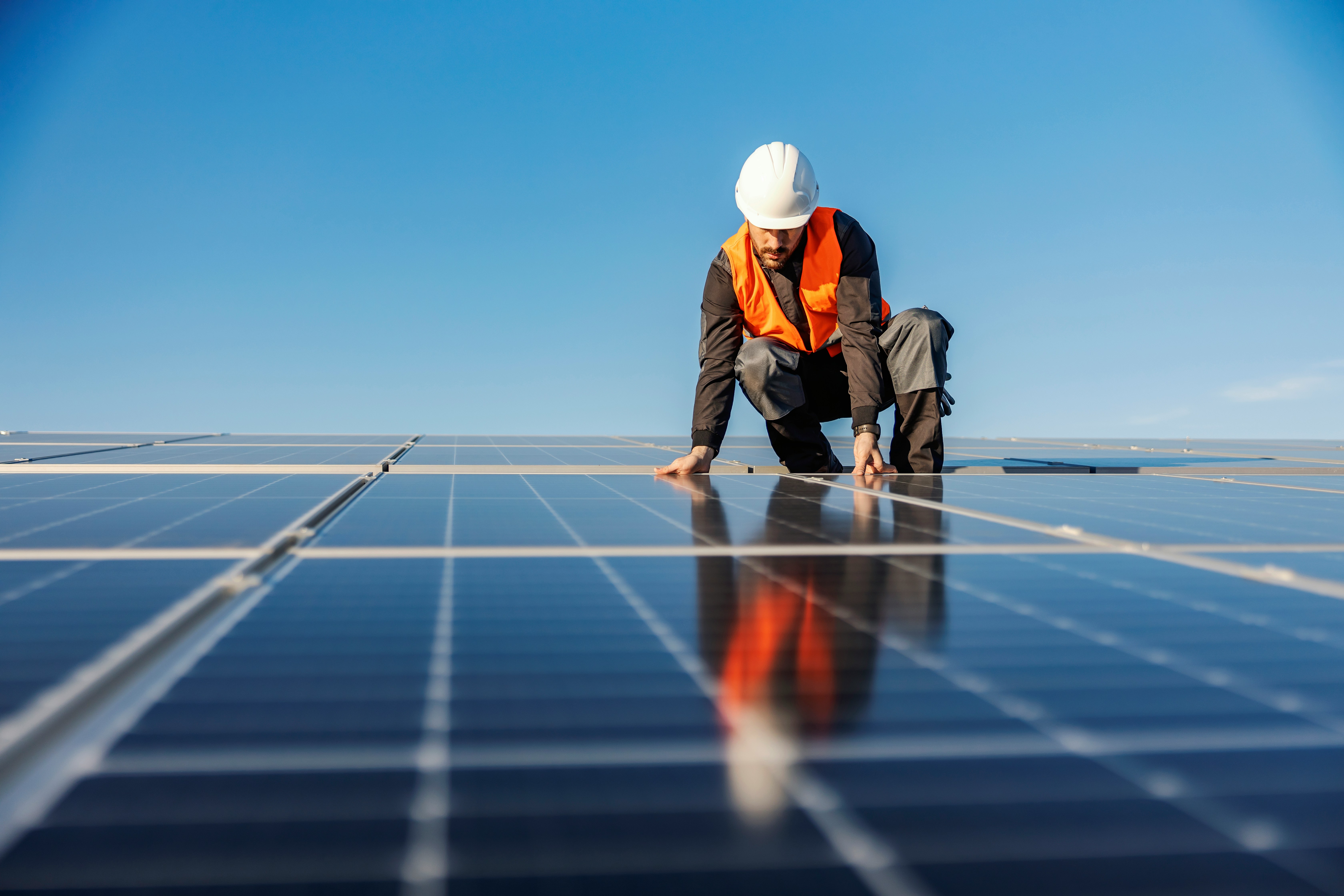 A worker installs a solar panel