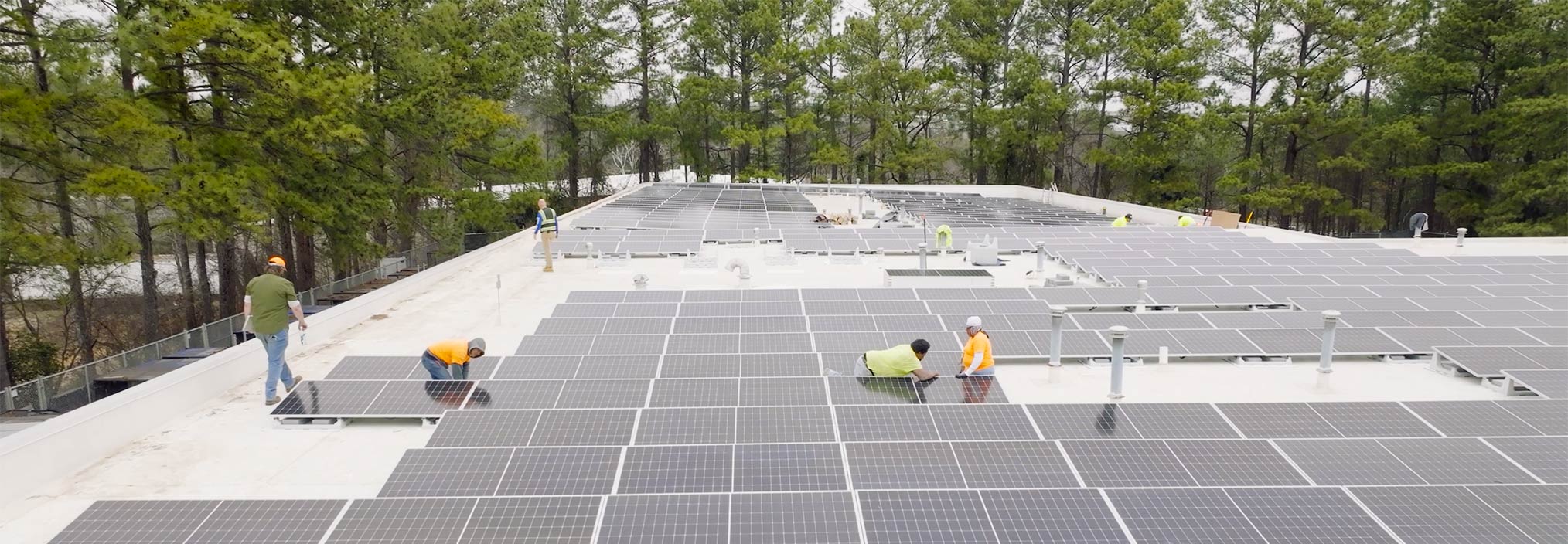 Workers install solar panels