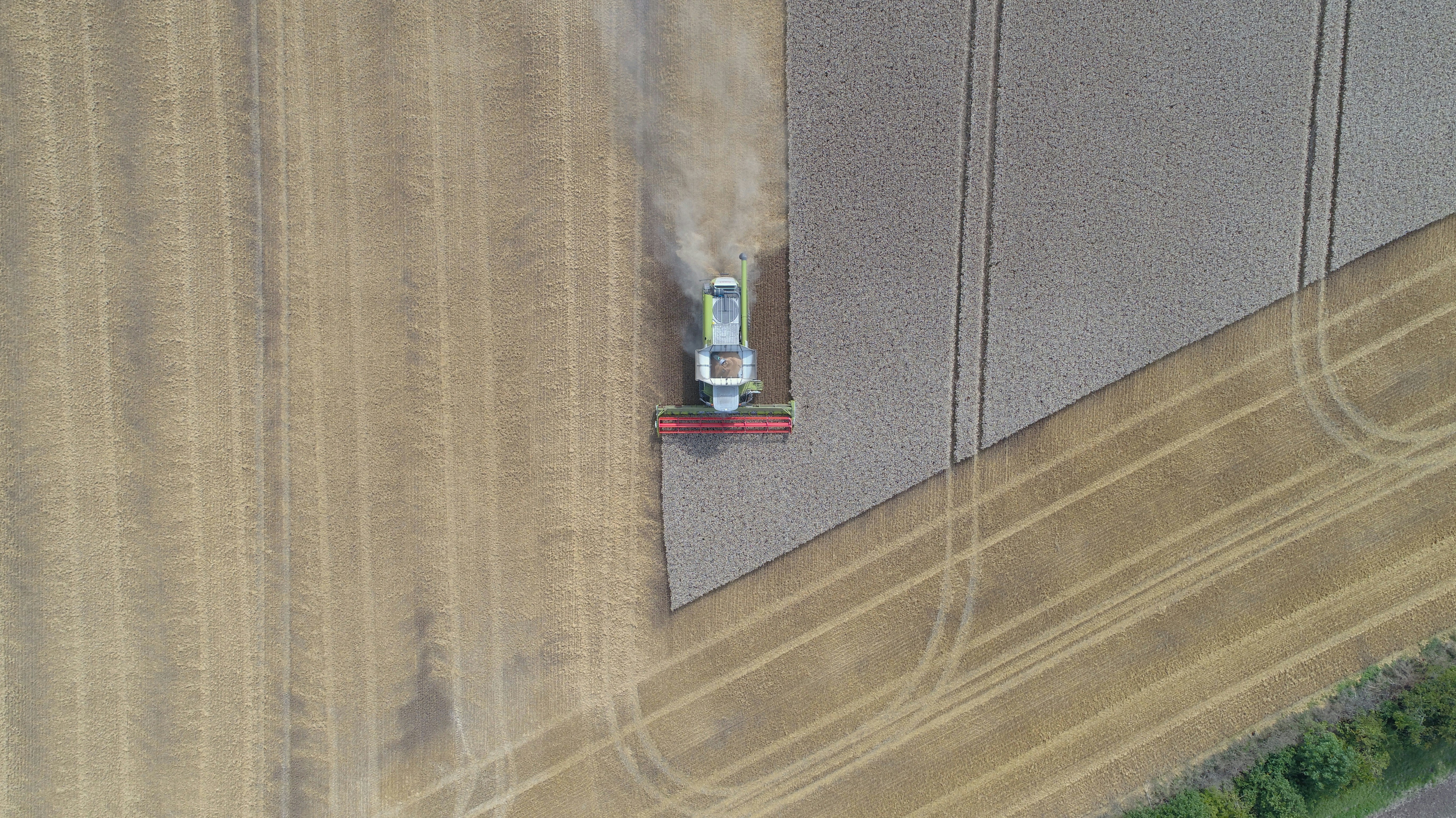 A farmer drives a plow through a field